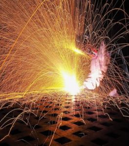 A person welding some metal.